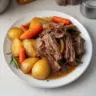Delicious oven baked pot roast served with vegetables and gravy