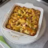 Delicious breakfast casserole with eggs, cheese, and vegetables in a baking dish.