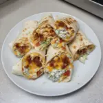 Cheesy bacon ranch wraps served on a plate with fresh ingredients