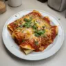 Cheesy rotisserie chicken enchiladas topped with melted cheese and fresh herbs