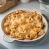 Delicious Chicken Enchilada Tortellini Bake topped with cheese and herbs