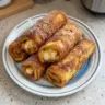 Delicious Cinnamon Sugar French Toast Roll-Ups served with syrup and berries