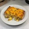 Delicious Classic Breakfast Hashbrown Casserole topped with cheese and herbs