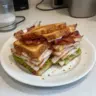 Crispy Ultimate Club Sandwich stacked with fresh ingredients and crispy bacon