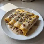 A plate of delicious breakfast enchiladas topped with sausage gravy