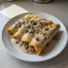 A plate of delicious breakfast enchiladas topped with sausage gravy