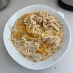 Bowl of easy Chicken Tetrazzini topped with parsley and cheese