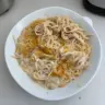 Bowl of easy Chicken Tetrazzini topped with parsley and cheese