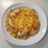 French onion chicken and rice bake served in a casserole dish with cheese.