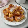 Delicious Hawaiian Roll French Toast topped with syrup and fruit
