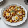 Delicious and colorful hearty breakfast hash with potatoes, eggs, and vegetables