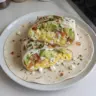 High-protein breakfast wrap with cottage cheese and avocado on a plate