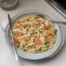 Creamy chicken pot pie orzo served in a cozy bowl for dinner.