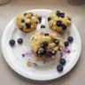 Freshly baked lemon blueberry muffins on a cooling rack
