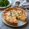 Delicious Mississippi Sin Quiche served on a plate, showcasing its rich ingredients.