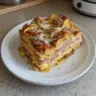 Monte Cristo Breakfast Casserole with layers of bread, ham, and cheese.