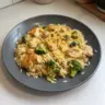 One-Pot Cheesy Chicken Orzo with broccoli in a skillet