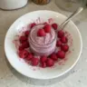 Delicious raspberry chia pudding topped with fresh berries and drizzled with maple syrup.