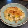 Rotisserie chicken and rice casserole topped with cheese and herbs