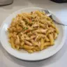 Delicious rotisserie chicken pasta dish served in a bowl with fresh herbs
