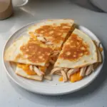 Rotisserie chicken quesadilla with melted cheese and fresh ingredients