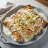 Creamy sour cream enchiladas with rotisserie chicken for a quick weeknight dinner