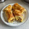 Sausage, Egg, and Cheese Breakfast Roll-Ups on a plate