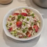 Strawberry Pecan Poppy Seed Chicken Salad in a bowl with fresh ingredients