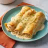 Delicious white rotisserie chicken enchiladas served with creamy sauce