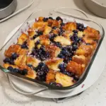 Delicious blueberry french toast casserole topped with fresh blueberries and syrup