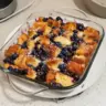 Delicious blueberry french toast casserole topped with fresh blueberries and syrup