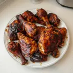 Delicious BBQ chicken sizzling on the grill, perfect for summer gatherings.
