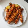 Delicious BBQ Pineapple Chicken Kabobs on a grill, ready to serve.