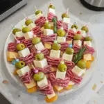 Colorful charcuterie skewers with meats, cheeses, and fresh vegetables