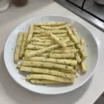 A bowl of crispy homemade potato sticks served as a snack.