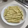 A bowl of crispy homemade potato sticks served as a snack.