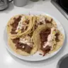 Delicious smoked BBQ beef tacos served with fresh toppings