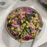 Delicious high-protein miso bowl garnished with fresh vegetables and herbs