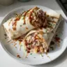 BBQ chicken coleslaw wraps on a serving plate ready to eat