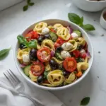 Delicious tortellini salad with colorful vegetables and dressing