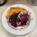 Delicious homemade blackberry batter cake topped with fresh blackberries.