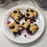 Delicious blackberry cobbler bars topped with a crumbly crust and fresh blackberries.