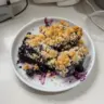 Delicious serving of blueberry crisp dessert with fresh blueberries and oats