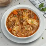 Bowl of delicious cabbage roll soup topped with fresh herbs