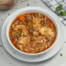 Bowl of delicious cabbage roll soup topped with fresh herbs