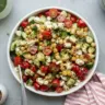 Bowl of fresh Caprese Chickpea Salad with tomatoes, mozzarella, and basil.