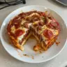 Cheesy Egg and Marinara Bake served in a baking dish with fresh herbs