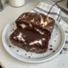 Delicious chocolate zucchini bread with cream cheese filling on a wooden table