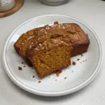 Loaf of classic spiced pumpkin bread with pumpkin seeds and spices