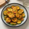 Crispy cheesy air fryer zucchini served on a plate